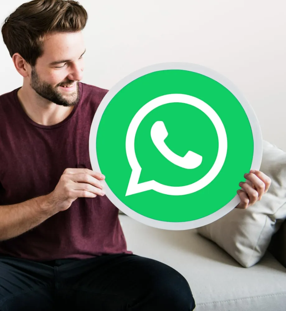 Man holding WhatsApp logo